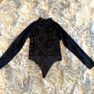 Black velvet cold-shoulder onesie with lace design